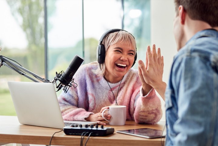 Couple Trying to Boost Your Online Presence by Recording Podcast Or Broadcasting Interview On Radio In Studio At Home With Laptop